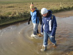 SX11264 Annie and Jenni walking through icy puddle.jpg